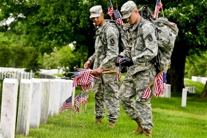 Soldiers place flags at Arlington National Cemetery